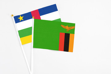 Zambia and Central African Republic stick flags on white background. High quality fabric, miniature national flag. Peaceful global concept.White floor for copy space.