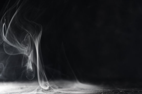 Smoke on dark background with copyspace