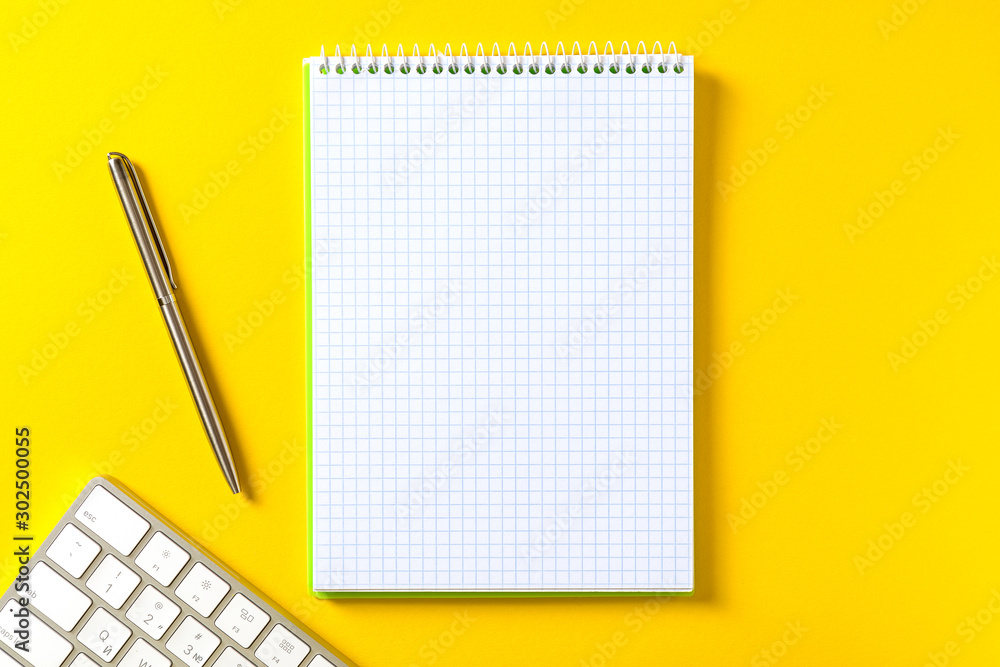 Poster the white open notepad and computer keypad isolated on the yellow