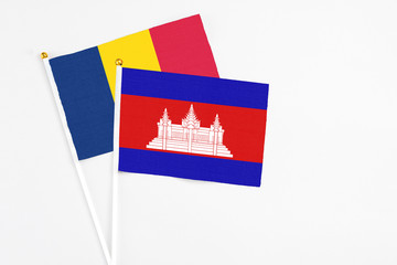 Cambodia and Chad stick flags on white background. High quality fabric, miniature national flag. Peaceful global concept.White floor for copy space.
