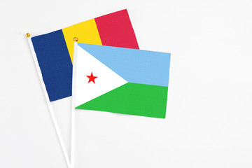 Djibouti and Chad stick flags on white background. High quality fabric, miniature national flag....