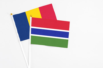 Gambia and Chad stick flags on white background. High quality fabric, miniature national flag. Peaceful global concept.White floor for copy space.