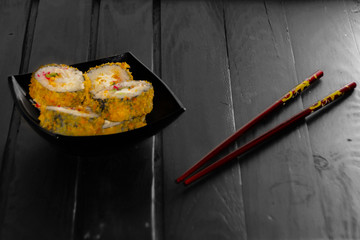 rolls in a black plate on black Board sticks