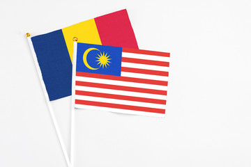 Malaysia and Chad stick flags on white background. High quality fabric, miniature national flag. Peaceful global concept.White floor for copy space.