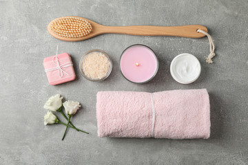 Flat lay with spa supplies on grey background, space for text