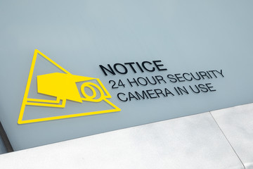 "Notice. 24 Hour Security Camera in Use" sign