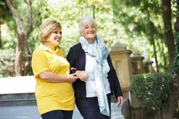 Careful caregiver taking care of the patient, outdoors.