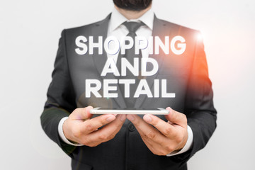 Text sign showing Shopping And Retail. Business photo text Process of Selling Consumer Goods Services to customers Male human wear formal work suit hold smart hi tech smartphone use hands
