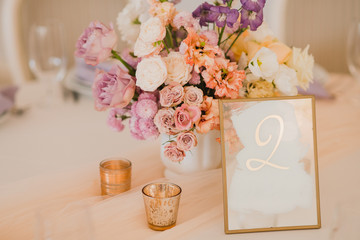 Coziness and style. Modern event design. Table setting at wedding reception. Floral compositions...