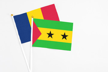 Sao Tome And Principe and Chad stick flags on white background. High quality fabric, miniature national flag. Peaceful global concept.White floor for copy space.