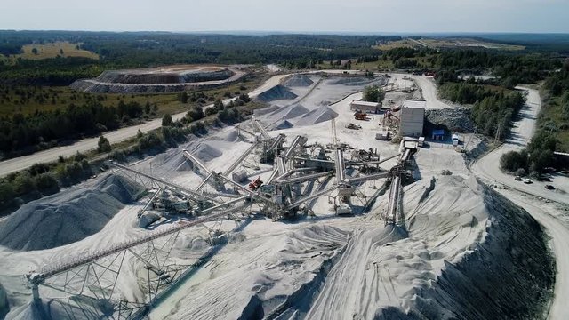 Aerial view  of crusher works with rubble at extraction site. Rock stone crushing machine at a mining quarry. 