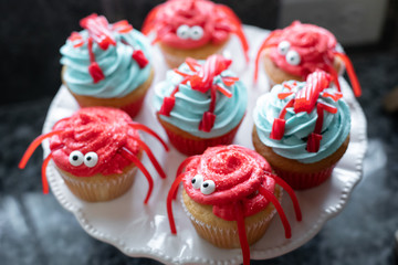 Display of licorice crabs and lobsters on seafood themed cupcakes