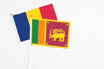 Sri Lanka and Chad stick flags on white background. High quality fabric, miniature national flag. Peaceful global concept.White floor for copy space.