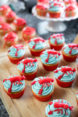 Licorice lobster cupcakes in a seafood dessert display