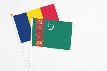 Turkmenistan and Chad stick flags on white background. High quality fabric, miniature national...