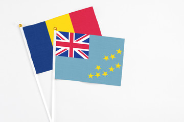 Tuvalu and Chad stick flags on white background. High quality fabric, miniature national flag. Peaceful global concept.White floor for copy space.