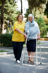 Daughter cares for mother. Health visitor and a senior woman