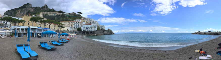 Fototapeta na wymiar background panoramic view of the coast and the beach of the city of Amalfi, Amalfi coast, Italy, Europe