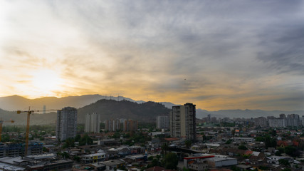 Fototapeta premium city and hill at dawn with construction crane