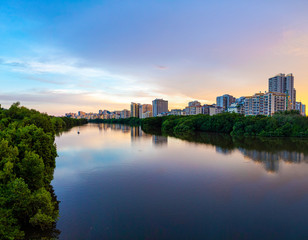Naklejka premium Sanya Cityscape with Sanya River View and Apartment Buildings in the sunset time, Hainan Province, China