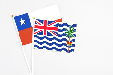 British Indian Ocean Territory and Chile stick flags on white background. High quality fabric, miniature national flag. Peaceful global concept.White floor for copy space.