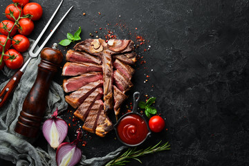 Sliced roast veal steak with rosemary and spices. Top view. Free space for your text.