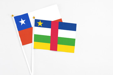 Central African Republic and Chile stick flags on white background. High quality fabric, miniature national flag. Peaceful global concept.White floor for copy space.