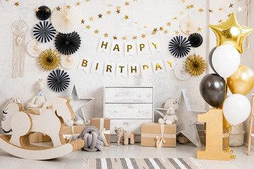 Birthday decorations with gifts, toys, balloons, garland and figure 1 for little baby party on a...