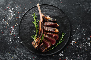 Grilled sliced beef steak with rosemary and spices. Top view. Free space for your text.