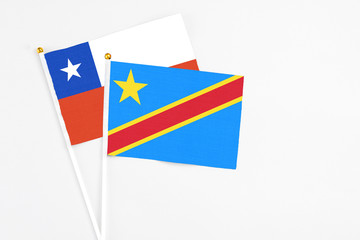 Congo and Chile stick flags on white background. High quality fabric, miniature national flag. Peaceful global concept.White floor for copy space.