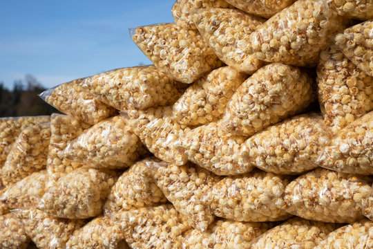 Stack of kettle corn in bags with a blue sky background