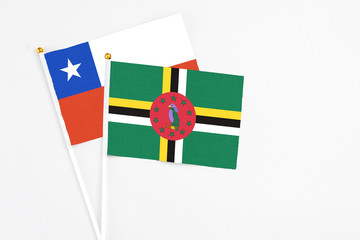 Dominica and Chile stick flags on white background. High quality fabric, miniature national flag....