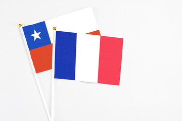 France and Chile stick flags on white background. High quality fabric, miniature national flag. Peaceful global concept.White floor for copy space.