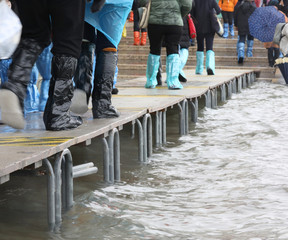 pedestrian boardwalk with people in Venice Italy