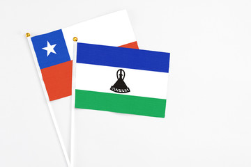 Lesotho and Chile stick flags on white background. High quality fabric, miniature national flag....