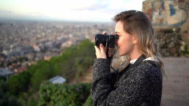 Portrait of female photographer with city in background