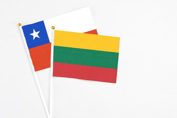 Lithuania and Chile stick flags on white background. High quality fabric, miniature national flag. Peaceful global concept.White floor for copy space.