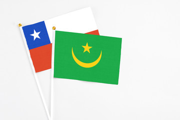 Mauritania and Chile stick flags on white background. High quality fabric, miniature national flag. Peaceful global concept.White floor for copy space.