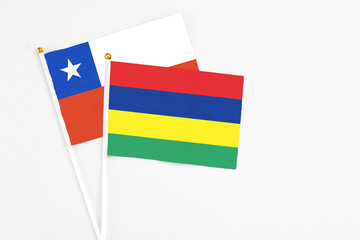 Mauritius and Chile stick flags on white background. High quality fabric, miniature national flag. Peaceful global concept.White floor for copy space.