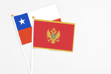 Montenegro and Chile stick flags on white background. High quality fabric, miniature national flag. Peaceful global concept.White floor for copy space.