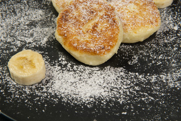 Cottage cheese pancakes on a dark plate