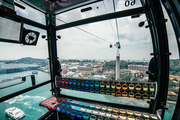 View for Turquoise Sea with Ships and Island with Entertainment from Cable Car to Sentosa in Singapore