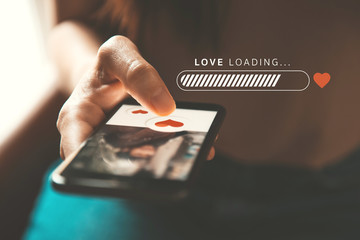 Love loading progress, Finger of woman pushing heart icon on screen in mobile smartphone application. Online dating app, valentine's day concept. - obrazy, fototapety, plakaty