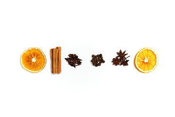 Composition made of dried orange, cinnamon, black pepper, star anice and clove on white background. Top view, copy space. Set of spices for mulled wine.