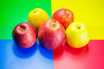 fresh fruits, apples red and green on a colored background