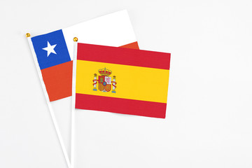 Spain and Chile stick flags on white background. High quality fabric, miniature national flag. Peaceful global concept.White floor for copy space.