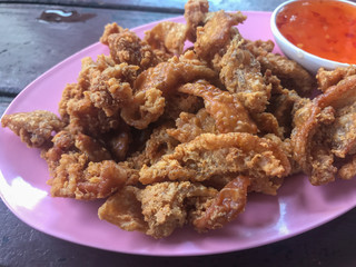 deep fried skin chicken on plate with sauce