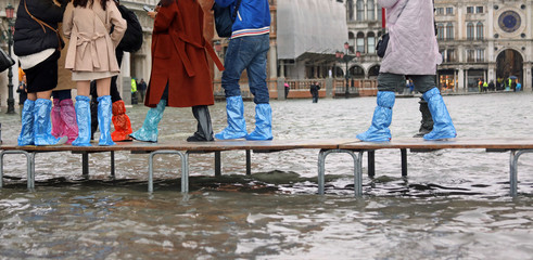 many people on the pedestrian boardwalk in Venice in Italy durin