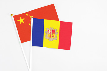Andorra and China stick flags on white background. High quality fabric, miniature national flag. Peaceful global concept.White floor for copy space.