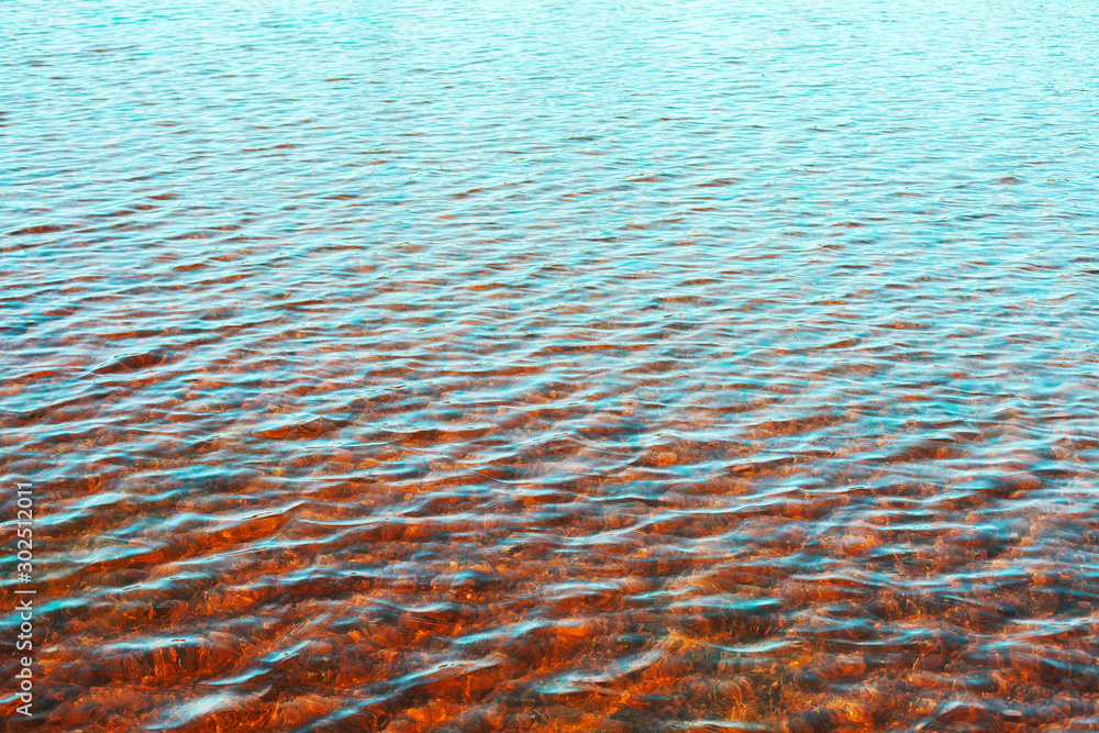 Wall mural Sea water surface with ripple reflections